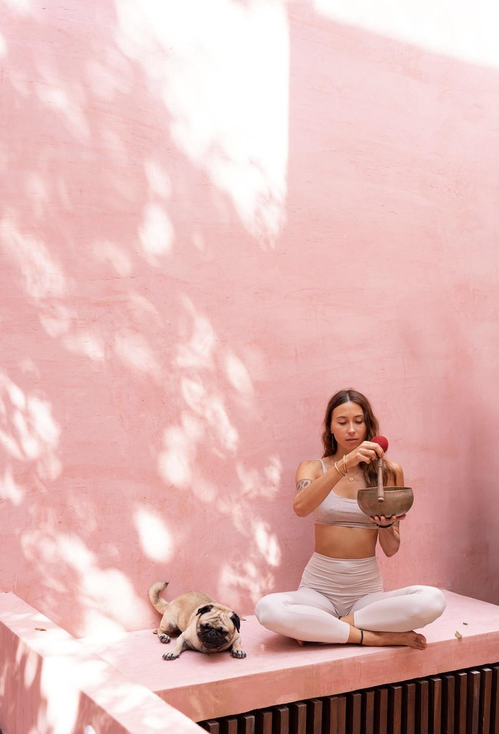 Natalia Orlova with a singing bowl and her dog